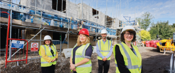 Jan Quarrington with the Caredig team outside one of their housing developments